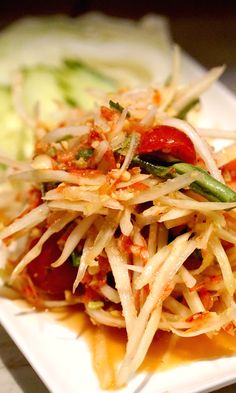 a white plate topped with pasta and veggies