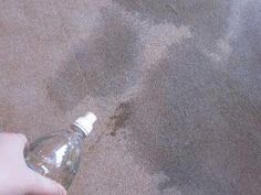 a person is holding a water bottle in their left hand while standing on the sand