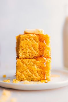 two pieces of cake sitting on top of a white plate