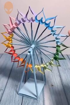 a colorful paper sculpture on top of a wooden table