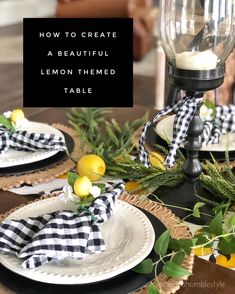 a black and white table setting with lemons, greenery and plaid napkins