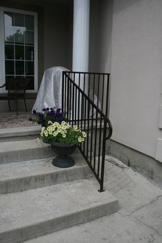 a planter filled with flowers sitting on the steps