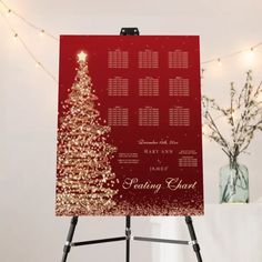 a red christmas card sitting on top of a easel