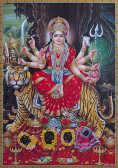 the hindu goddess sitting on top of a tiger