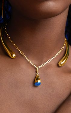 Modern and minimalist, this sculptural set features a gradient, open-ended shape. Wear to make a simple yet stunning statement. Handcrafted in recycled brass by artisans in Kenya. Gold products are 24k gold plated brass and match our brass style in color and tone. Your purchase promotes artisan innovation + entrepreneurship. Dimensions: Glass bead dimensions: 0.39in x 0.90in (10mm x 23mm) Chain length: 18.11in (460 mm) Modern Jewelry Necklaces, Jewelry Gold Modern, Gold Teardrop Necklaces Hand Forged, Gold Teardrop Hand Forged Necklace, Innovation And Entrepreneurship, Gold Collar Necklace, Shape Wear, Liquid Gold, Necklace Charm