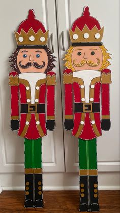 two cardboard nutcrackers are standing next to each other