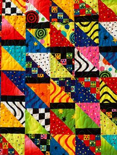 a colorful quilt with many different designs on it