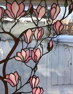 a stained glass window with pink flowers on it