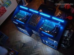 two turntables sitting on top of a wooden floor