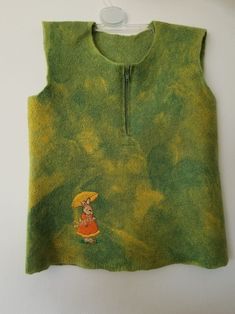 a green sweater with a cartoon character on it and an umbrella hanging from the front