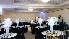 a banquet room set up with black and white decorations