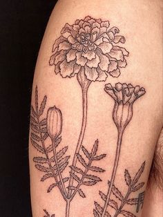 a close up of a person's arm with flowers on it