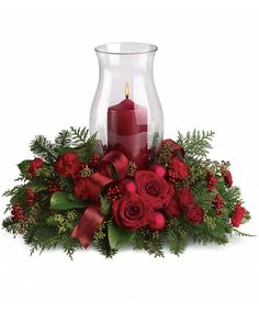 Glow ahead and send this spectacular centerpiece to anyone who's on your Christmas list this year. A glowing hurricane candle takes center stage but the surrounding festive touches make this arrangement radiate joy.  Centerpiece is round, roughly 12" to 14" in width. Jul Diy, Christmas Centers, Christmas Candle Decorations, Christmas Flower Arrangements, Christmas Floral Arrangements, Christmas Centerpieces Diy, Christmas Arrangements, Christmas Flowers, Deco Floral