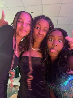 three young women posing for the camera