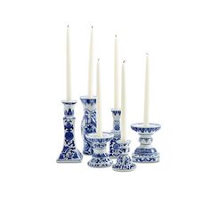 a group of blue and white vases sitting next to each other with candles in them