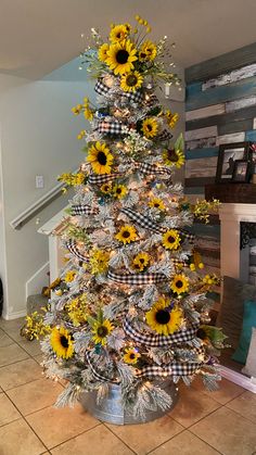 a decorated christmas tree with sunflowers on it