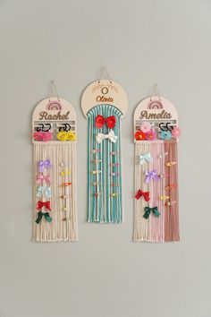 three decorative wall hangings with ribbons and bows on them, one for the door