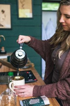 a woman pours coffee into a mug