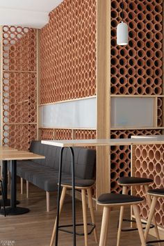 the interior of a restaurant with wooden partitions