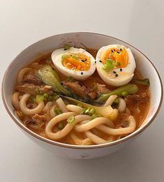 a bowl filled with noodles and hard boiled eggs