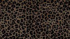 an animal print fabric with black and brown spots on the top, it is very dark