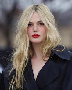 a woman with long blonde hair and red lipstick