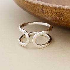 Forged by hand in solid sterling silver, the Open Cuff Ring embraces the finger with its mirrored curve design. The thick-gauge silver is hammered and filed to create a smooth, flat surface that sits comfortably between fingers. When the ring is hammered, the silver is work-hardened, resulting in a sturdy, non-adjustable band. This ring is made-to-order by hand in our bespoke metalsmithing studio in Stockport, New York. Instead of casting multiples of our designs, we fabricate each element by hand the old-school way using torches, hammers, and files on raw silver. Therefore, each ring is truly handmade and one-of-a-kind. Details: - Solid sterling silver - Available in sizes 5-12 Please allow up to three business days for the creation of your ring. Forged Jewelry, Hand Forged Jewelry, Open Cuff Ring, Cuff Ring, Curve Design, Cuff Rings, Silver Jewelry Rings, Flat Surface, Hand Forged