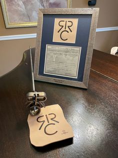 a table with a sign that says rcc on it next to a framed photo