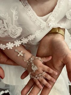 two people wearing wedding rings and bracelets