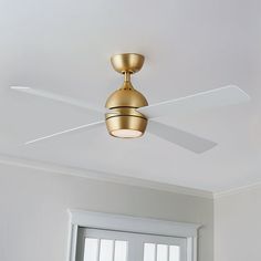 a ceiling fan in a room with white walls