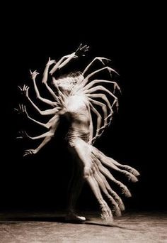 an artistic photo of a woman dancing with her hands in the air