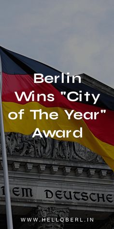 a german flag flying in front of a building with the words berlin wins city of the year award