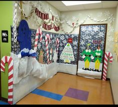 an office decorated for christmas with paper machs and candy canes on the floor