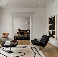 a living room filled with furniture and white walls