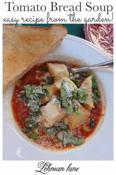 a white plate topped with soup next to a piece of bread