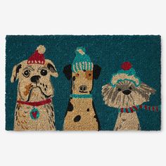 a blue door mat with three dogs wearing hats and scarfs on it's side