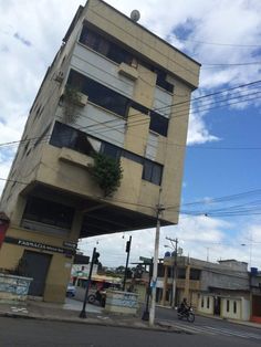 a tall building sitting on the side of a road