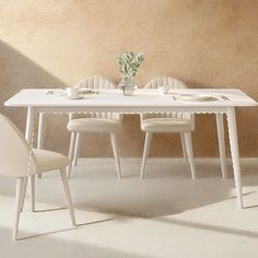 a white table with four chairs around it