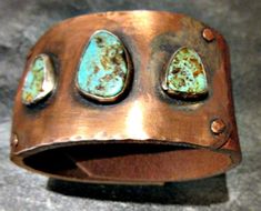 "Three's a crowd leather, turquoise, and copper distressed wide cuff, 2 heavy bronze snaps, artisan cuff, cowgirl, urban chic, USA made. This cuff has 3 beautiful pieces of Nevada turquoise set in sterling bezels on brushed hammered copper. The statement piece is then riveted onto buffalo hide distressed leather with 2 heavy duty bronze snaps. Settings are for 2 sizes 7\" and 7 1/2\". Convo me with any questions. It is approx. 1 3/4\" in width. I can't get the photos to show off this cuff enough Copper Diy Projects, Cabachon Jewelry, Turquoise Coral Jewelry, Turquoise Statement Earrings, Crooked House, Silversmith Jewellery, Coral Jewelry, Wide Cuff