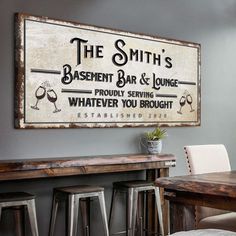 an old fashioned sign is hanging on the wall above a bar and dining room table