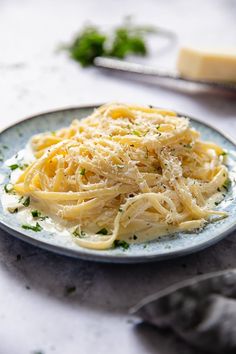 a plate of pasta with parmesan cheese on it