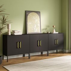 a living room with green walls and a white rug in front of a black cabinet