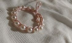 a close up of a bracelet on a bed