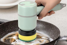 a person is using an electric device to stir food in a frying pan