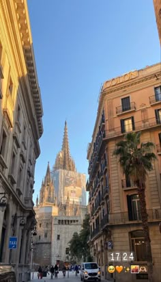 an old city street with tall buildings and palm trees in the foreground on a sunny day