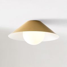 a white and gold ceiling light hanging from the ceiling in a living room or bedroom