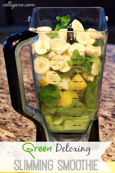 a blender filled with fruit and vegetables on top of a counter