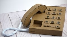 an old fashioned phone is in a cardboard box