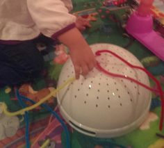 a child is playing with toys on the floor