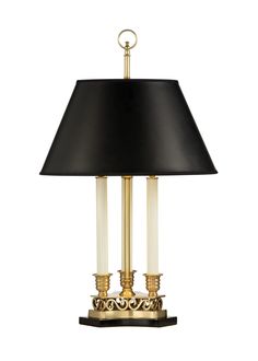 a table lamp with a black shade on the top and gold trimmings around it